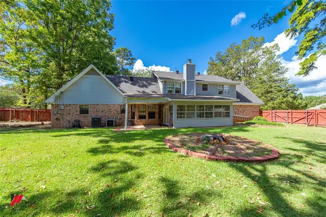 a view of backyard with table and chairs and potted plants