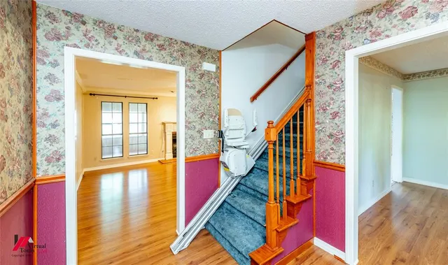 a view of an entryway with wooden floor and stairs