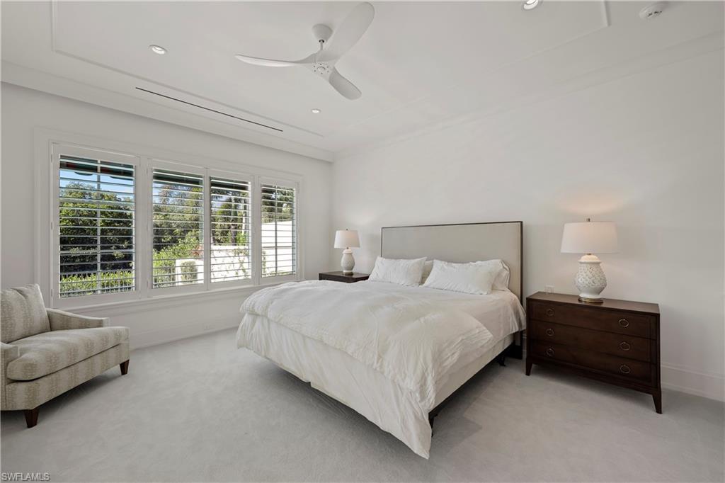 8057 Via Vecchia Naples, FL 34108 - Photo 14 of 42 a large bed sitting in a bedroom next to a window