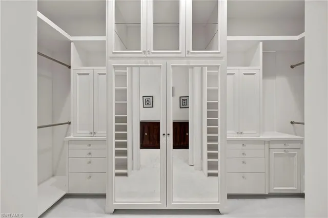 a large bedroom with a large bed and a large window