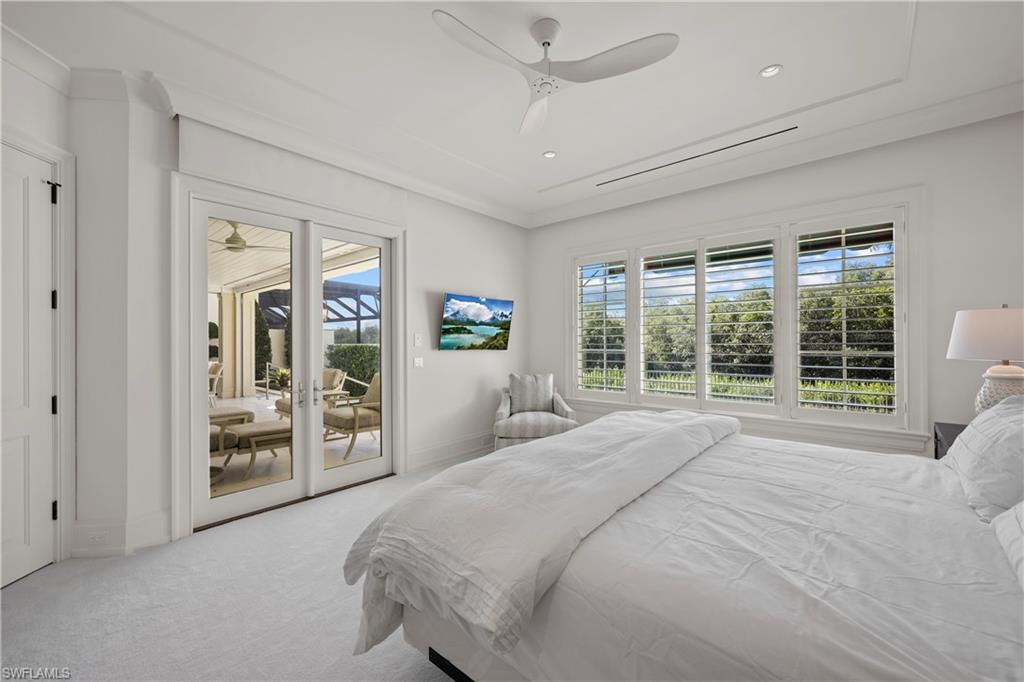8057 Via Vecchia Naples, FL 34108 - Photo 16 of 42 a large bedroom with a large bed and a large window