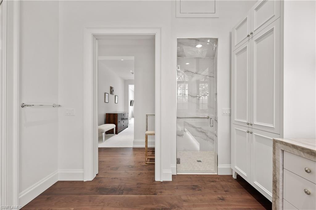 8057 Via Vecchia Naples, FL 34108 - Photo 19 of 42 wooden view of a hallway with wooden floor and staircase