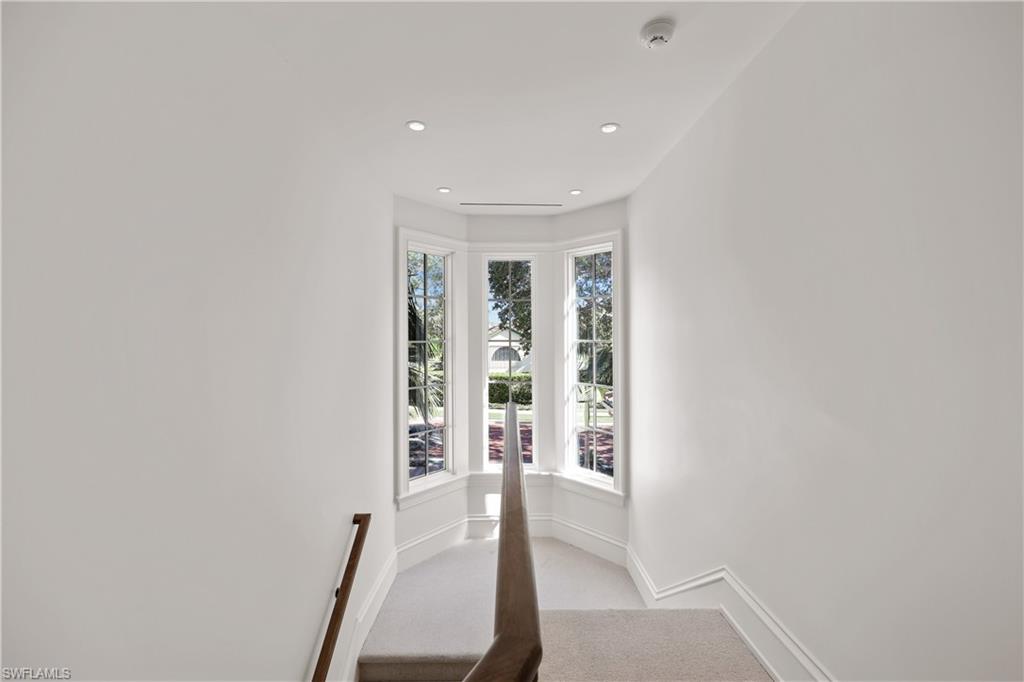 8057 Via Vecchia Naples, FL 34108 - Photo 20 of 42 wooden floor in an empty room with a window