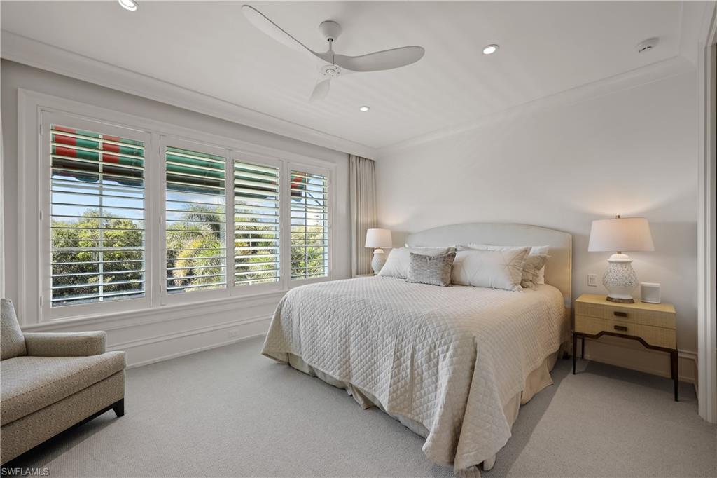 8057 Via Vecchia Naples, FL 34108 - Photo 23 of 42 a spacious bedroom with a bed and a couch