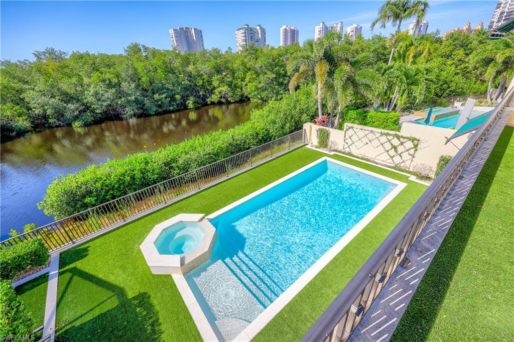 8057 Via Vecchia Naples, FL 34108 - Photo 27 of 42 a view of a pool with a bench and yard of the house