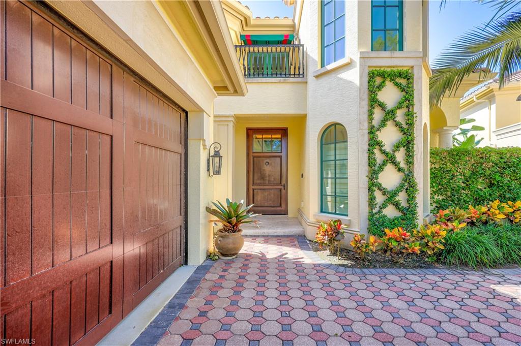 8057 Via Vecchia Naples, FL 34108 - Photo 3 of 42 a front view of a house with a yard