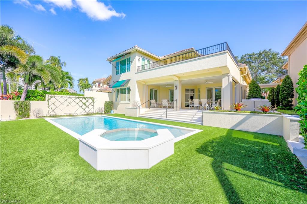 8057 Via Vecchia Naples, FL 34108 - Photo 40 of 42 a view of a house with swimming pool and a yard