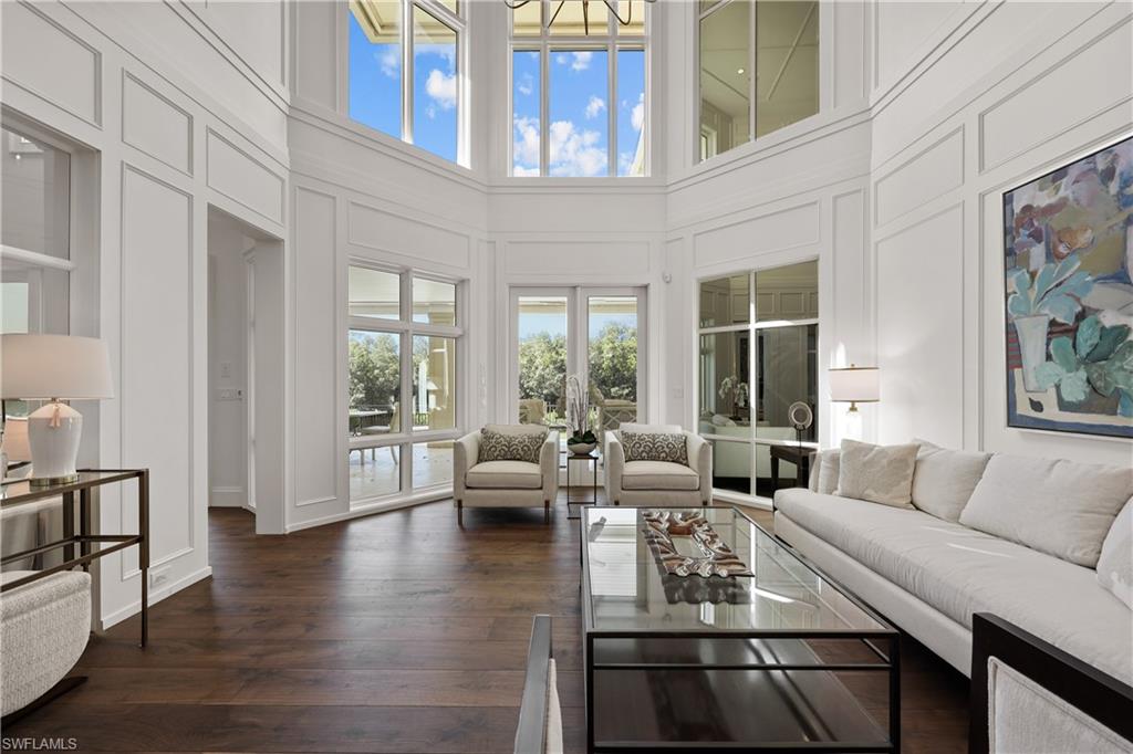 8057 Via Vecchia Naples, FL 34108 - Photo 6 of 42 a living room with furniture floor to ceiling window and wooden floor