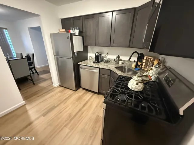 a kitchen with a sink appliances and cabinets