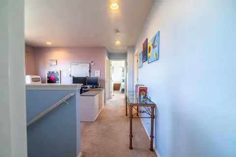 a kitchen view with stainless steel appliances wooden floor and a refrigerator