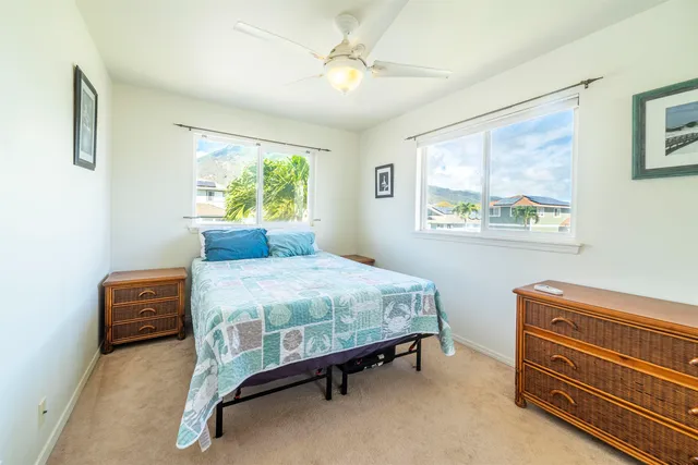 a bedroom with a bed dresser and a window