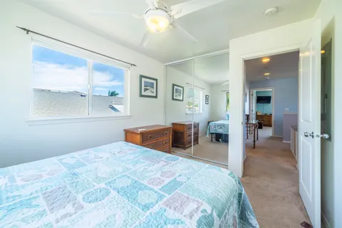 a bedroom with a large bed and a chandelier