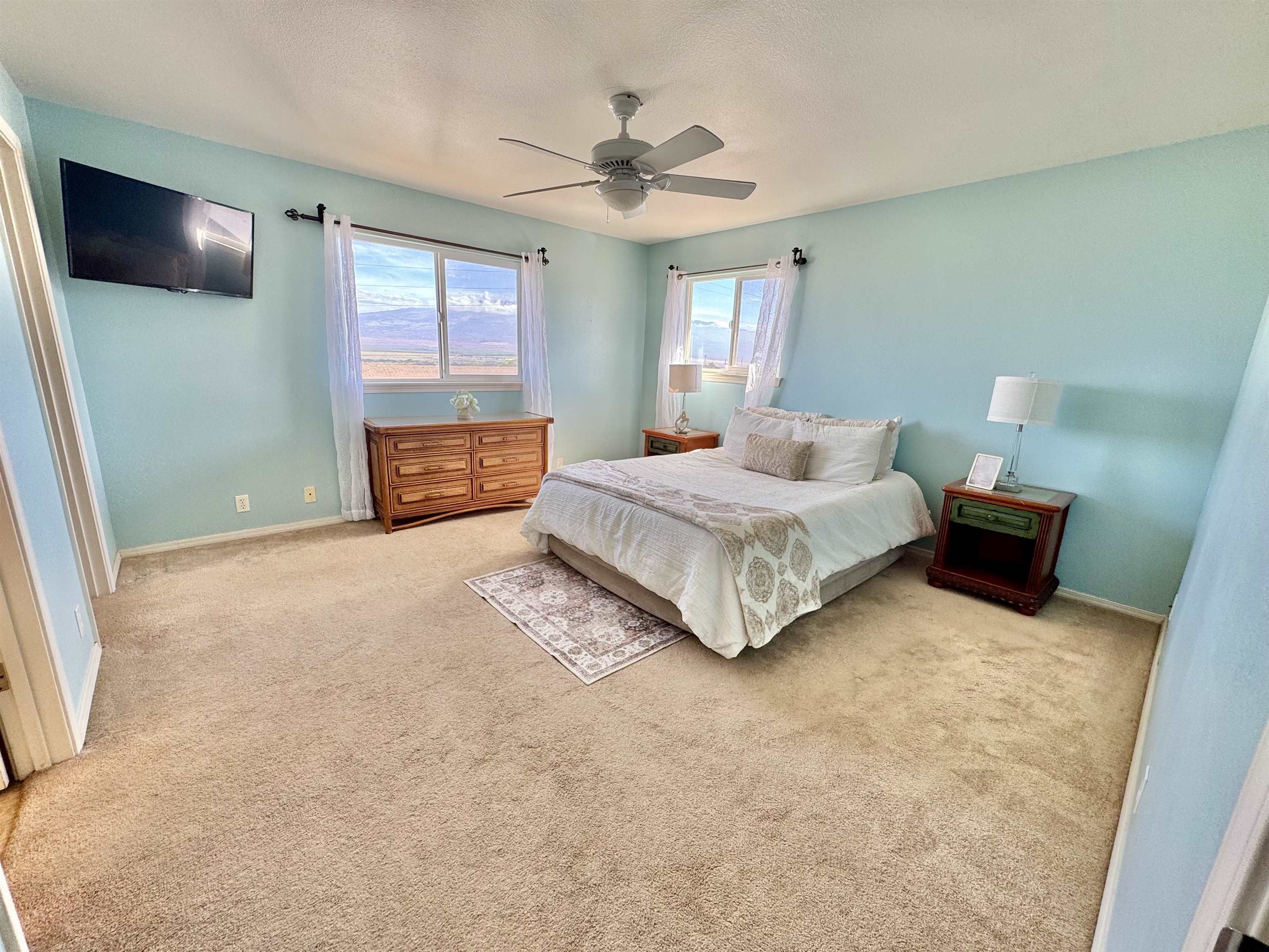 159 Iniiniki Street Wailuku, HI 96793 - Photo 17 of 33 a spacious bedroom with a bed and a flat screen tv