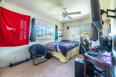 a bedroom with furniture and a flat screen tv