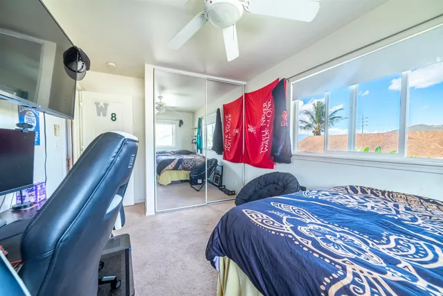 a bedroom with two bed and a window