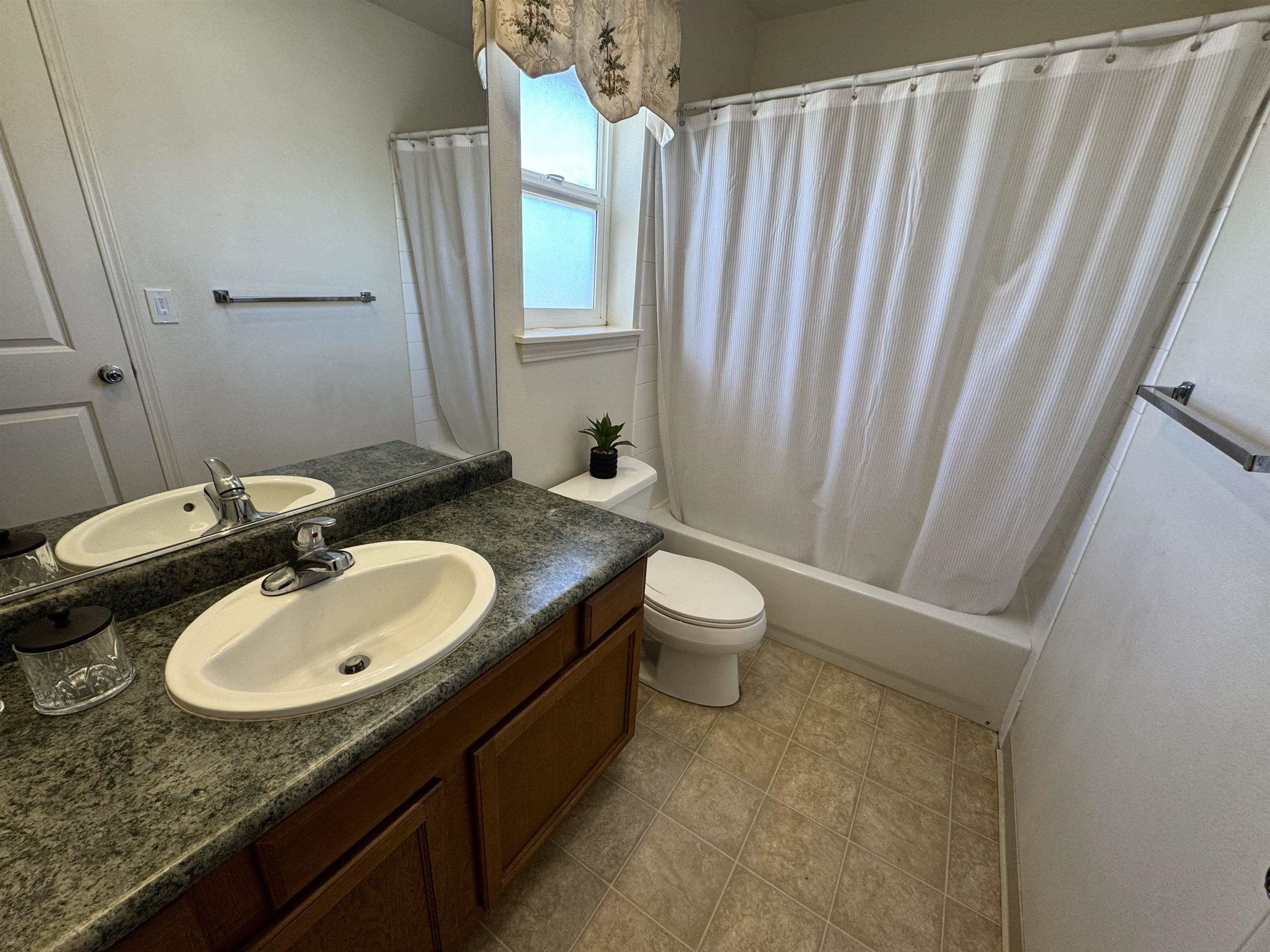 159 Iniiniki Street Wailuku, HI 96793 - Photo 23 of 33 a bathroom with a granite countertop sink and a mirror