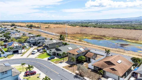 an aerial view of residential building with outdoor space and ocean view