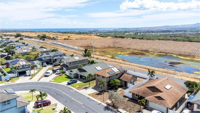 an aerial view of residential building with outdoor space and ocean view