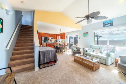 a living room with furniture and a chandelier