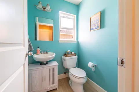a bathroom with a toilet sink and mirror