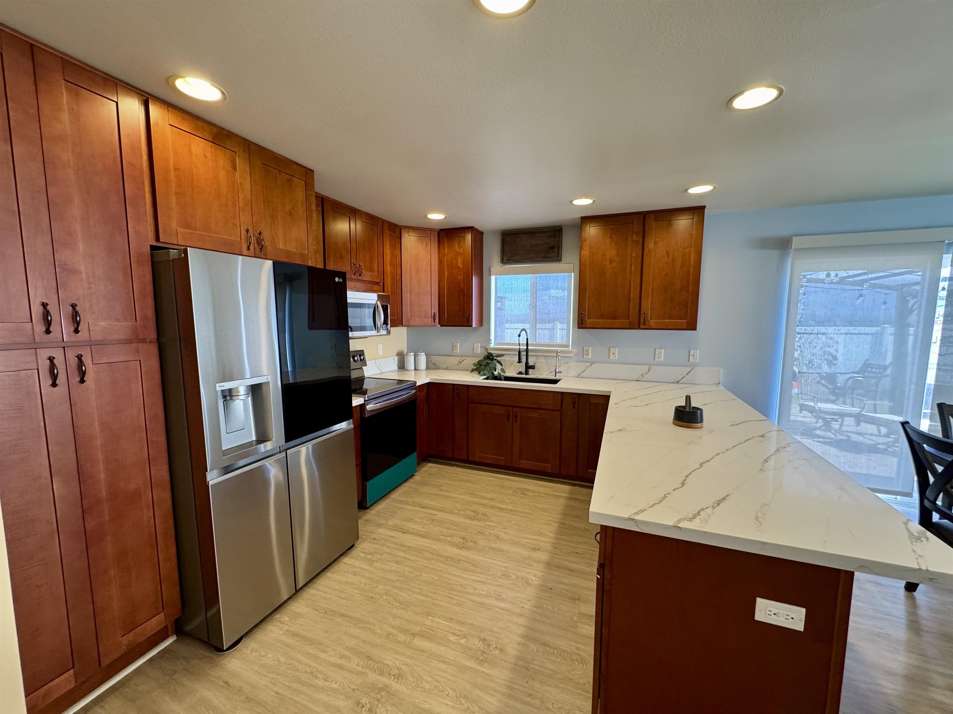 159 Iniiniki Street Wailuku, HI 96793 - Photo 7 of 33 a kitchen with stainless steel appliances a refrigerator sink and microwave