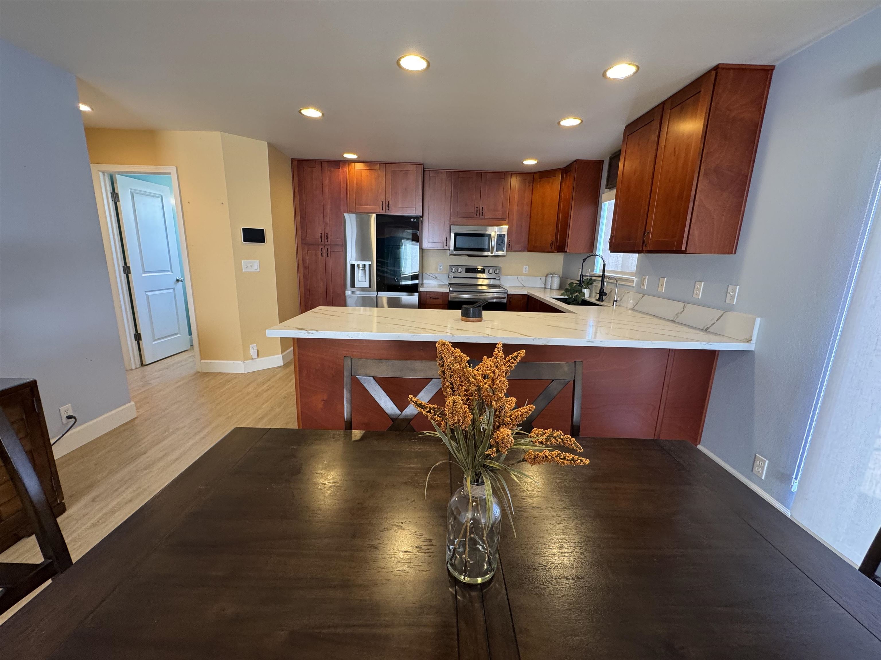 159 Iniiniki Street Wailuku, HI 96793 - Photo 8 of 33 a view of a dining room with furniture a chandelier and wooden floor