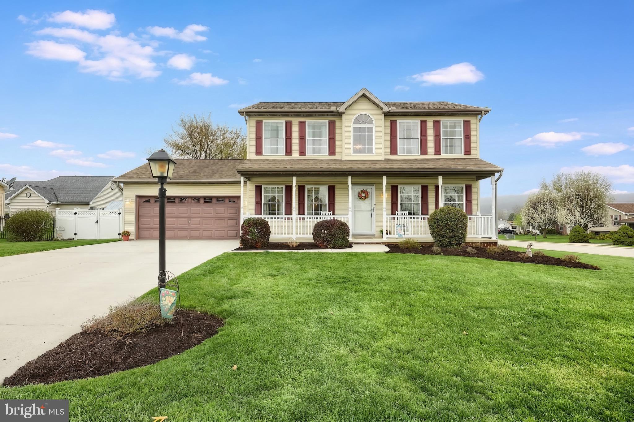 a front view of a house with a yard and porch