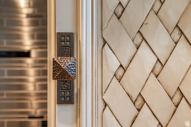 694 West Cephus Road Draper, UT 84020 - Photo 89 of 148 Custom hammered metal cabinet hardware with an ornate backplate, set against a painted cabinet frame