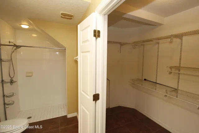 a bathroom with a shower and a toilet