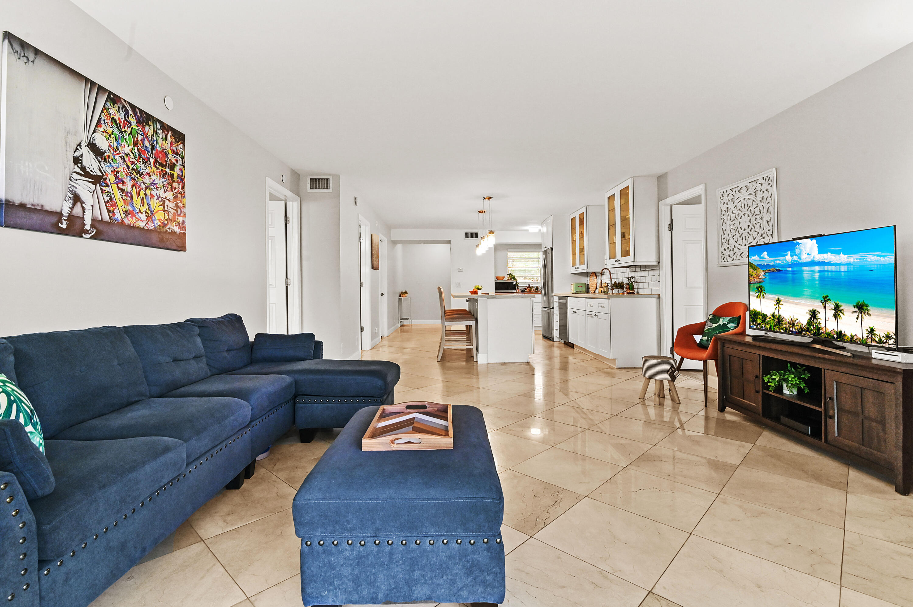6400 Northwest 2nd Avenue, Unit 124 Boca Raton, FL 33487 - Photo 17 of 33 a living room with furniture and a dining table with kitchen view