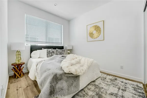 a bedroom with a bed and painting on the wall