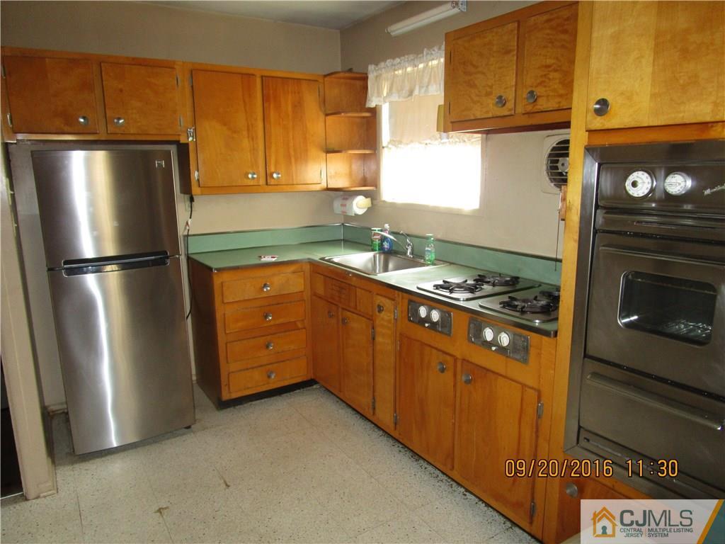 9 Baldwin Road Edison, NJ 08817 - Photo 4 of 8 a kitchen with stainless steel appliances granite countertop a refrigerator a stove and a sink
