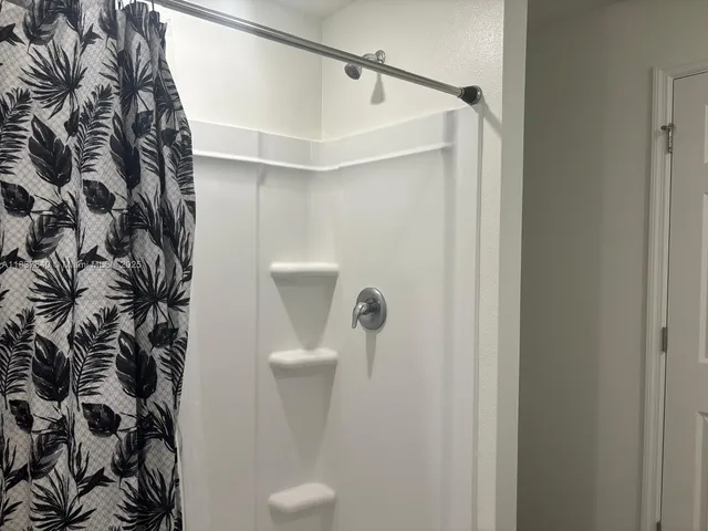 a bathroom with a shower and toilet