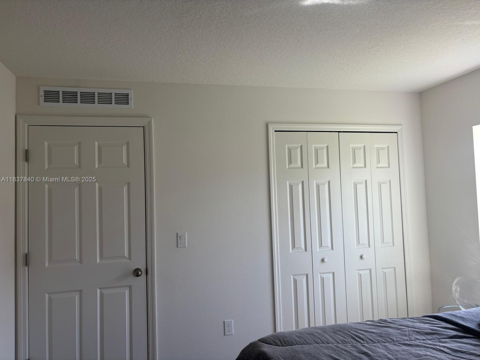 1073 Southwest Eureka Avenue, Unit 1073 Port St. Lucie, FL 34953 - Photo 15 of 25 a view of a bedroom with wooden floor