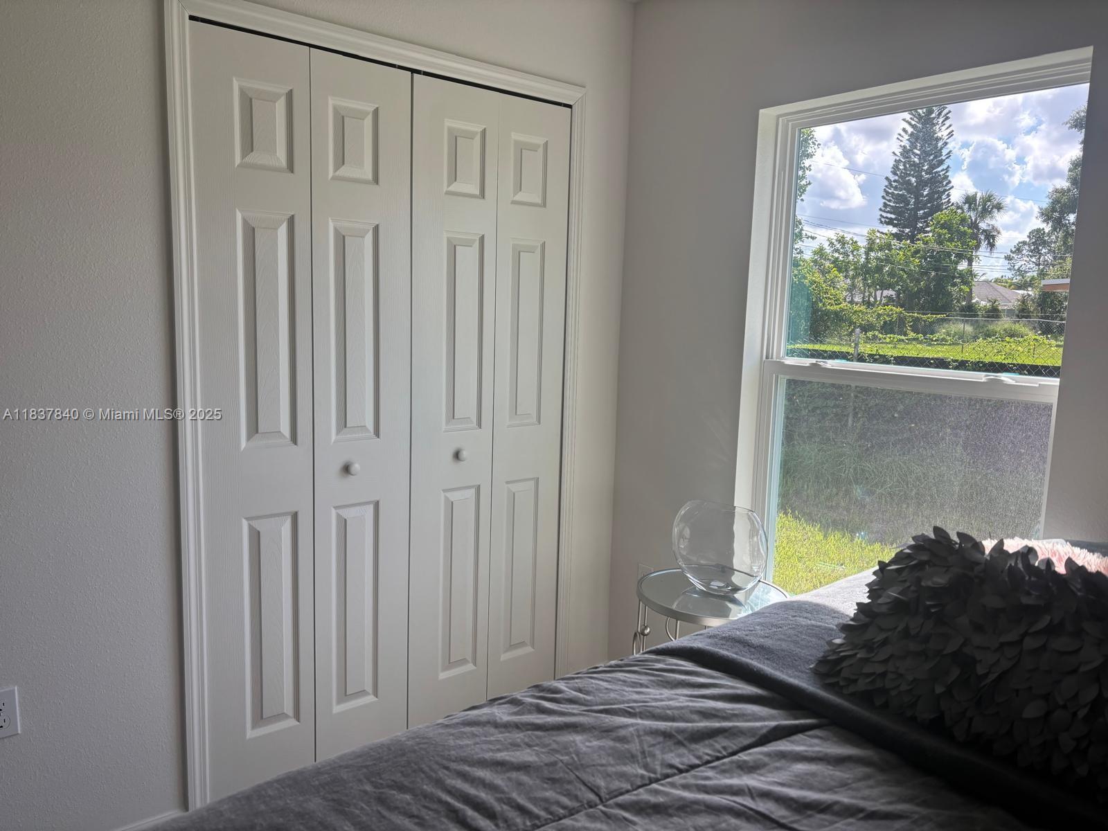 1073 Southwest Eureka Avenue, Unit 1073 Port St. Lucie, FL 34953 - Photo 16 of 25 a bedroom with a bed and a window