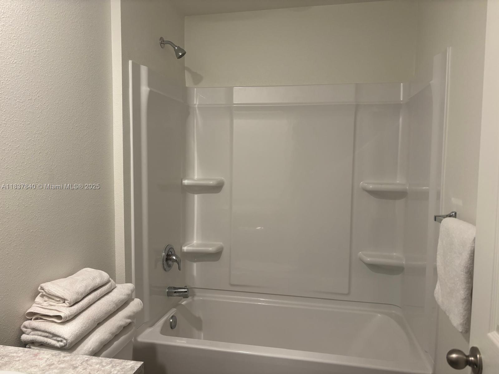 1073 Southwest Eureka Avenue, Unit 1073 Port St. Lucie, FL 34953 - Photo 19 of 25 a bathroom with a tub