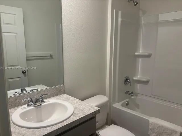 a bathroom with a sink toilet and bathtub