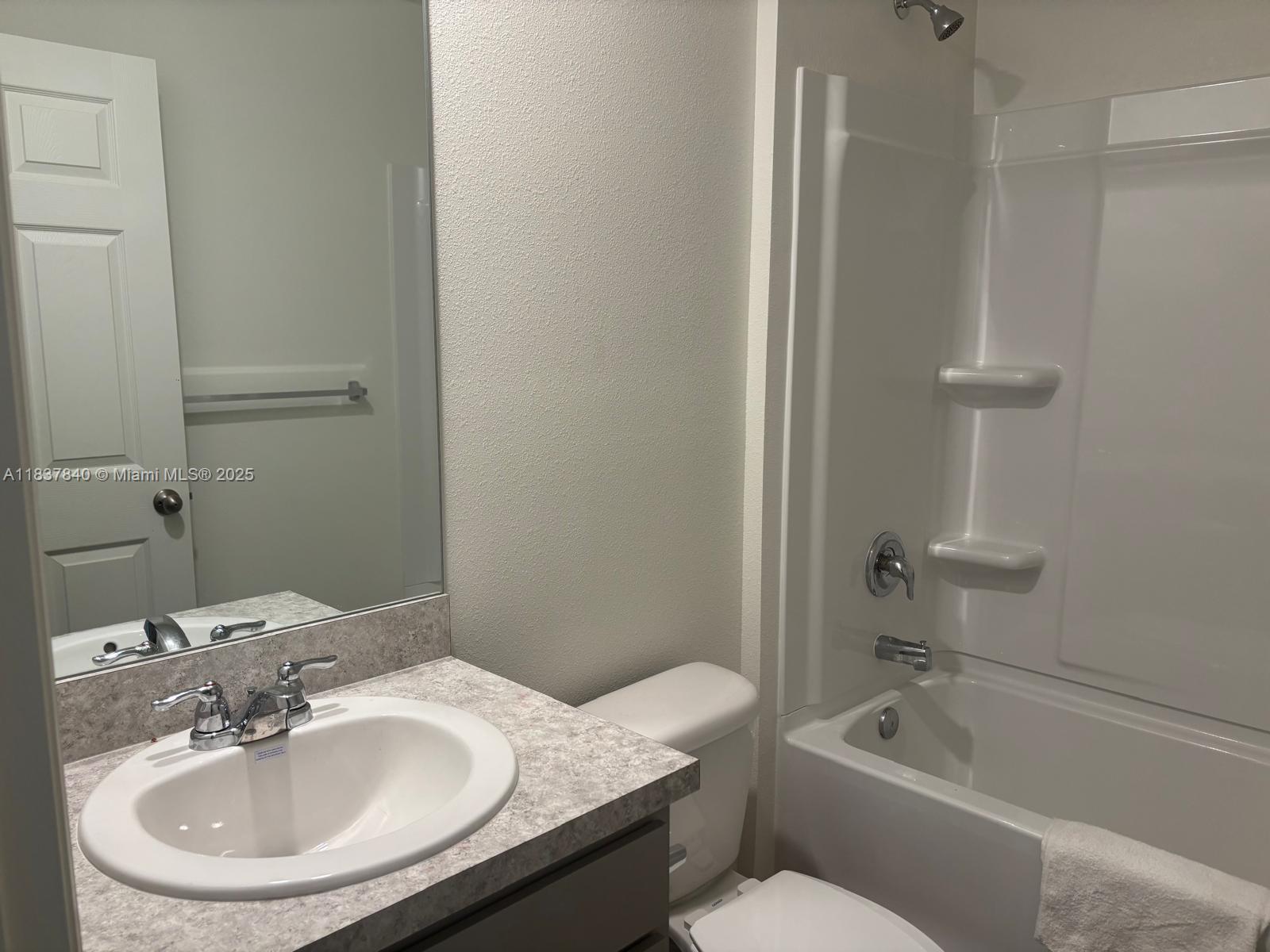 1073 Southwest Eureka Avenue, Unit 1073 Port St. Lucie, FL 34953 - Photo 21 of 25 a bathroom with a sink toilet and bathtub