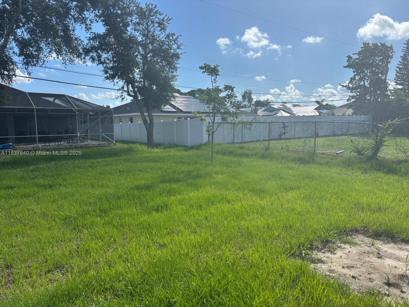 1073 Southwest Eureka Avenue, Unit 1073 Port St. Lucie, FL 34953 - Photo 24 of 25 a view of a house with a backyard