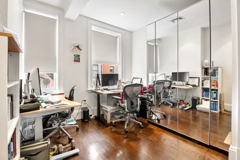 a view of a workspace with furniture and a living room