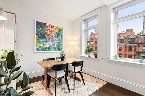 a view of a workspace with furniture and a potted plant