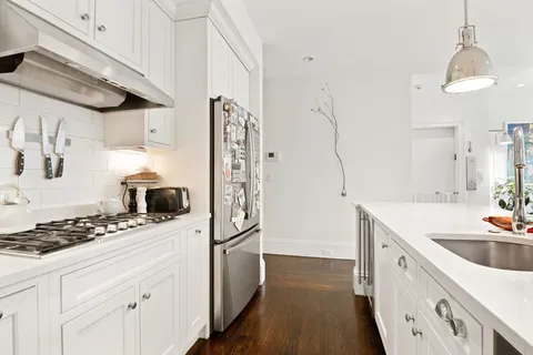 a kitchen with a stove a sink and a refrigerator
