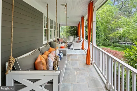 a view of balcony with wooden floor and outdoor seating