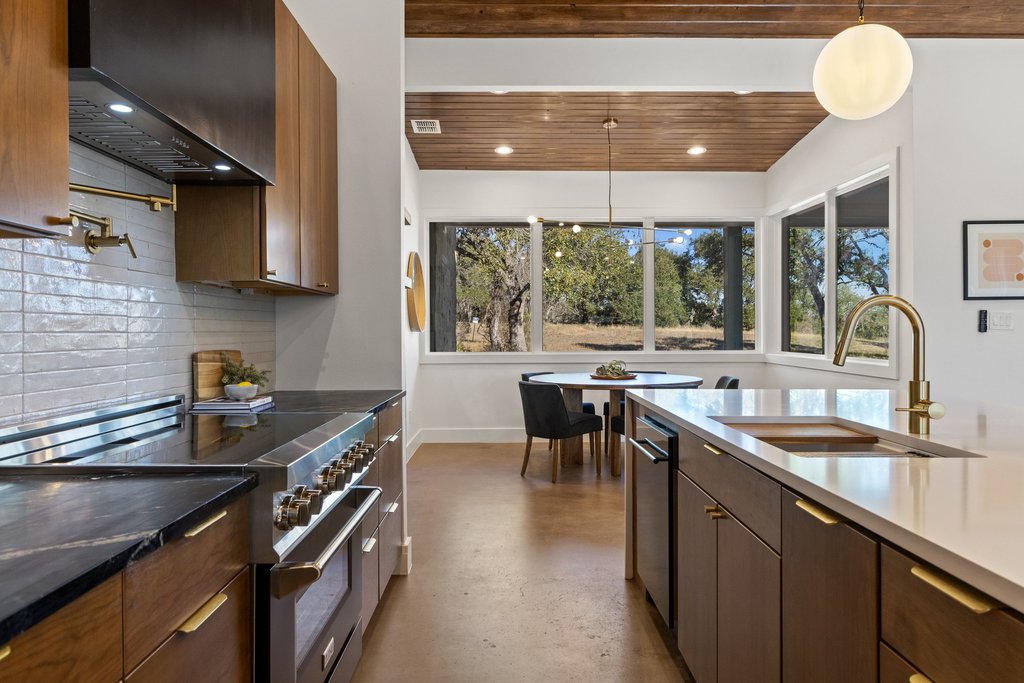 47 War Bonnet Wimberley, TX 78676 - Photo 5 of 40 a kitchen with granite countertop a sink stove and cabinets