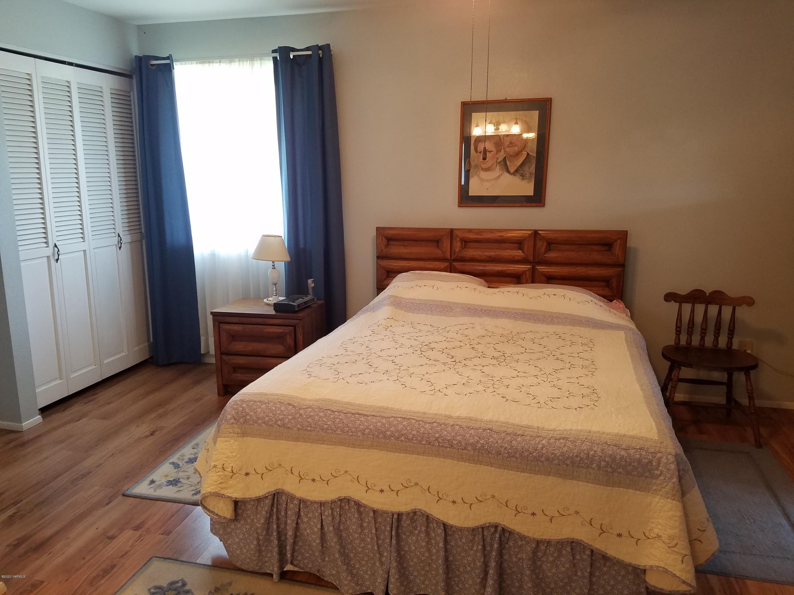 20 Roza View Road Grandview, WA 98930 - Photo 14 of 28 a bedroom with a bed and wooden floor