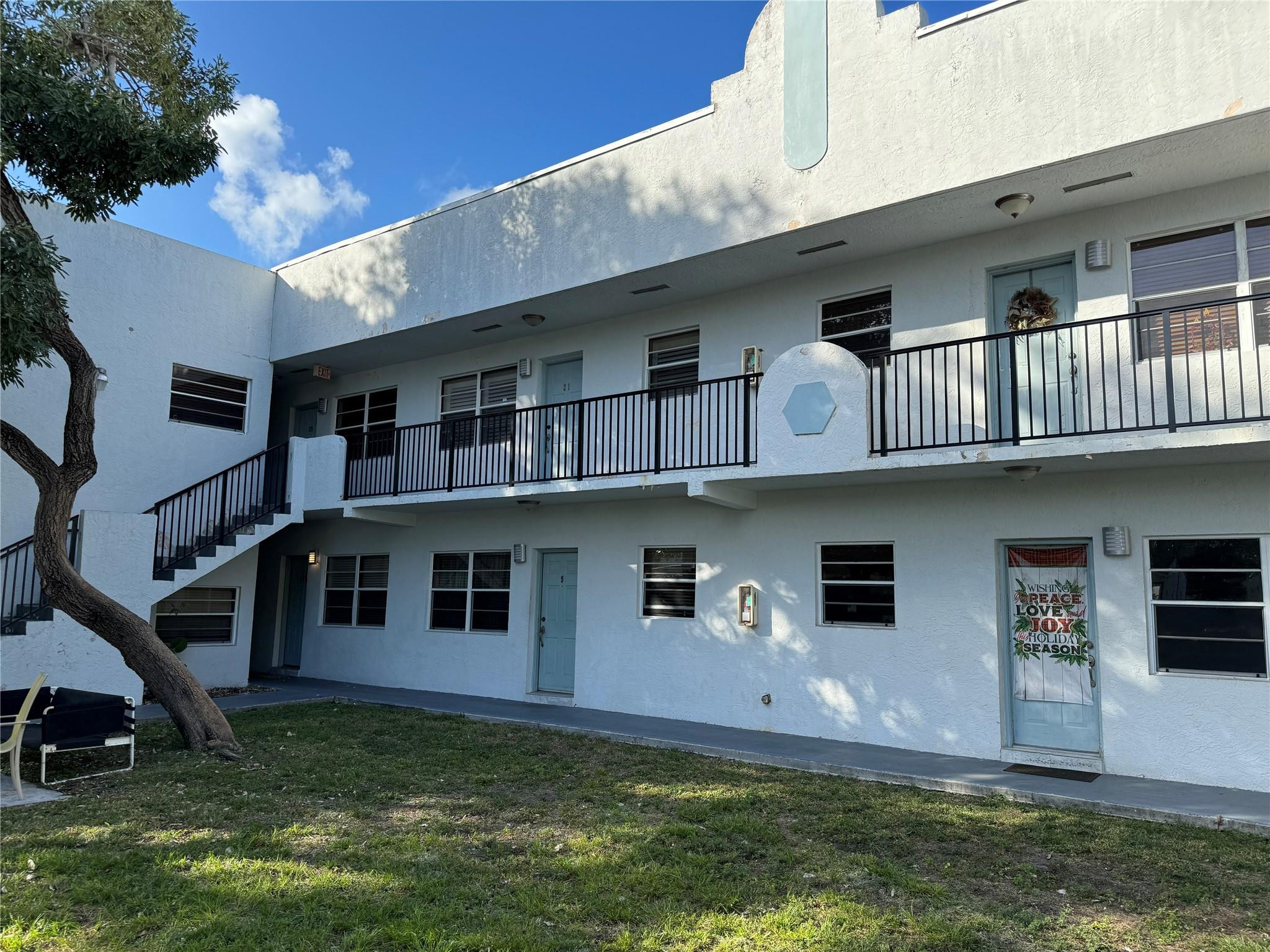 1925 Madison Street, Unit 21 Hollywood, FL 33020 - Photo 1 of 10 a front view of a house with a yard