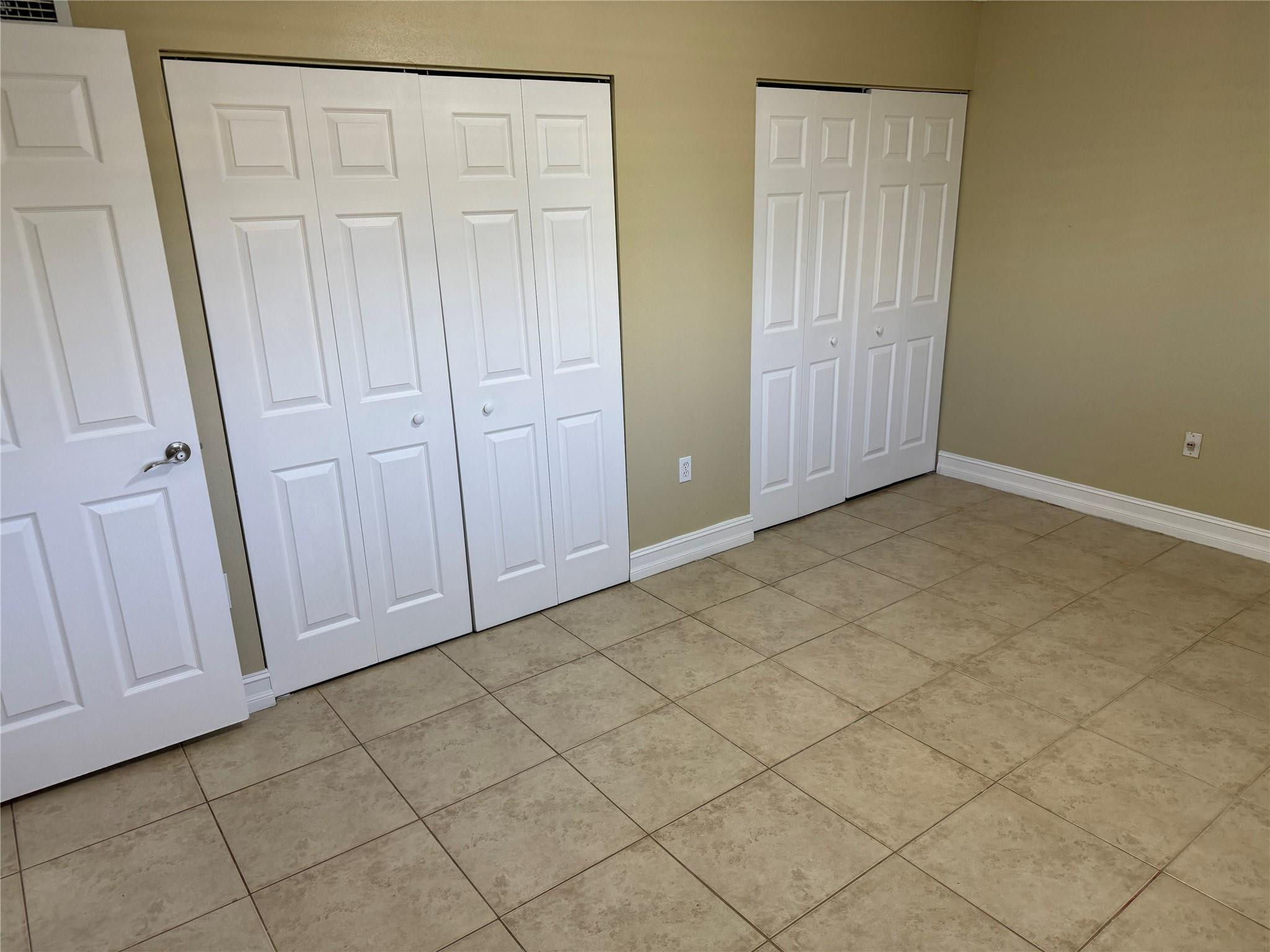 1925 Madison Street, Unit 21 Hollywood, FL 33020 - Photo 7 of 10 an empty room with a wooden door