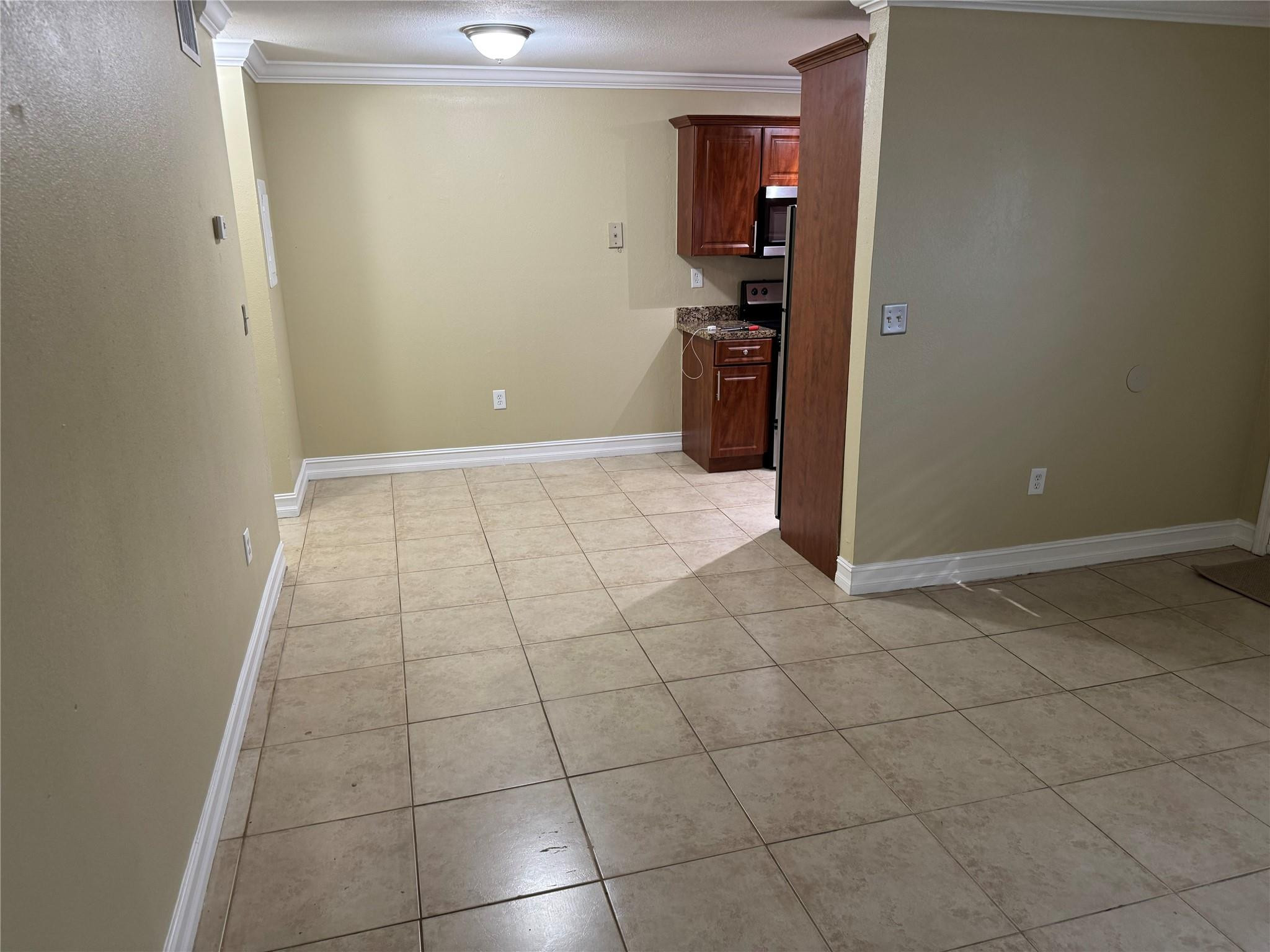 1925 Madison Street, Unit 21 Hollywood, FL 33020 - Photo 8 of 10 a view of a kitchen with a sink and a refrigerator