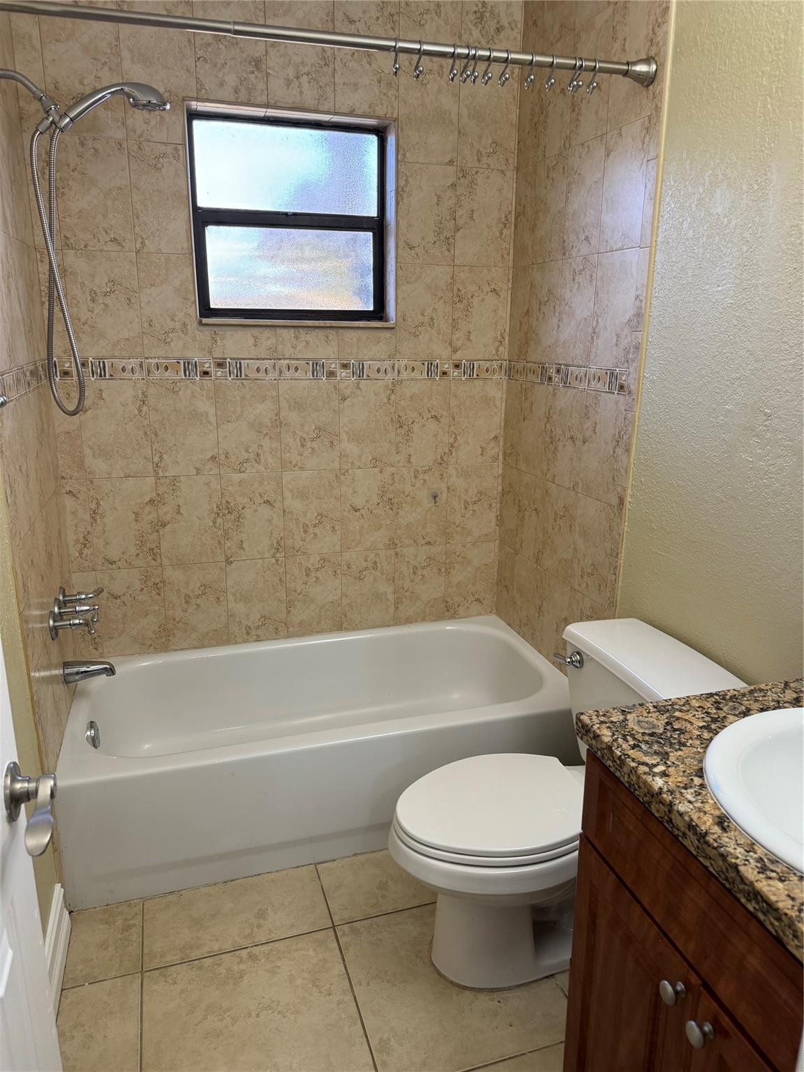 1925 Madison Street, Unit 21 Hollywood, FL 33020 - Photo 9 of 10 a bathroom with a granite countertop bathtub toilet and sink
