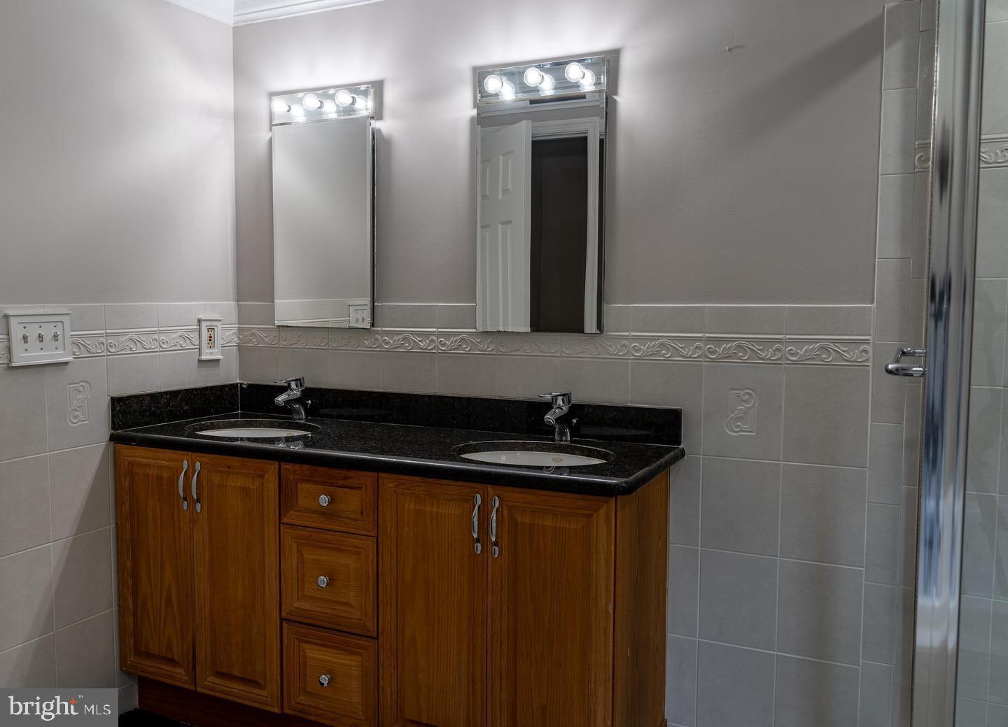 14913 Lear Lane Silver Spring, MD 20905 - Photo 20 of 33 Sleek dual vanity in modern bathroom.